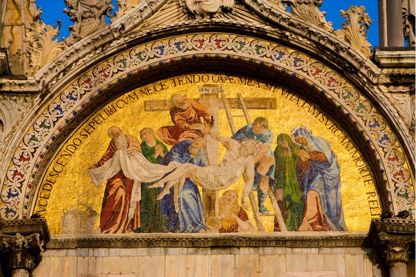 Photo of a golden mosaic on the facade of St. Mark’s Cathedral depicting Christ being taken down from the cross.
