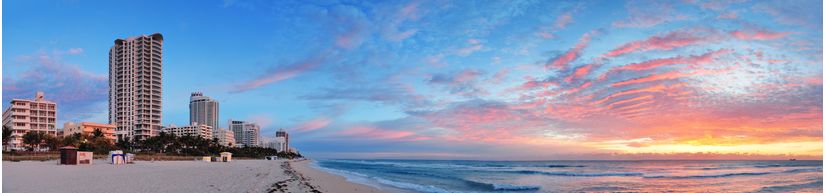 Pink-colored-clouds-from-the-sunset-fill-the-sky-over-the-Miami-skyline-and-beach