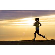 Woman Running At Sunset Wall Mural