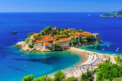 orange-roofed-resort-on-the-island-contrasts-stunningly-against-the-teal-blue-waters-of-the-sea