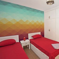 A-college-dorm-room-with-a-geometric-diamond-gradient-wallpaper-from-blue-to-red
