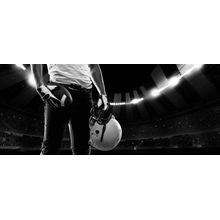 Football Player Standing Against A Night Stadium Mural