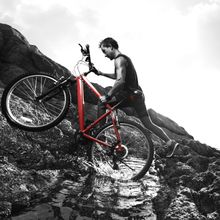 Biker Crossing Water With Bike Wall Mural