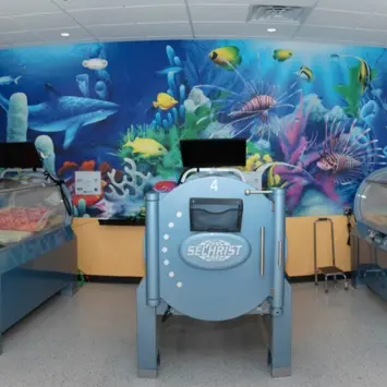 A colorful under-the-sea wall mural in a hospital treatment center