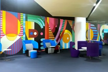 Colorful, dynamic geometric wall mural in a commercial real estate office lobby