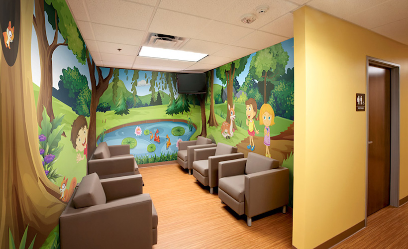 Forest pond landscape with kids and animals illustrated wall mural in pediatric lobby