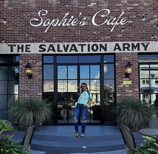 Sophie standing in front of her new cafe