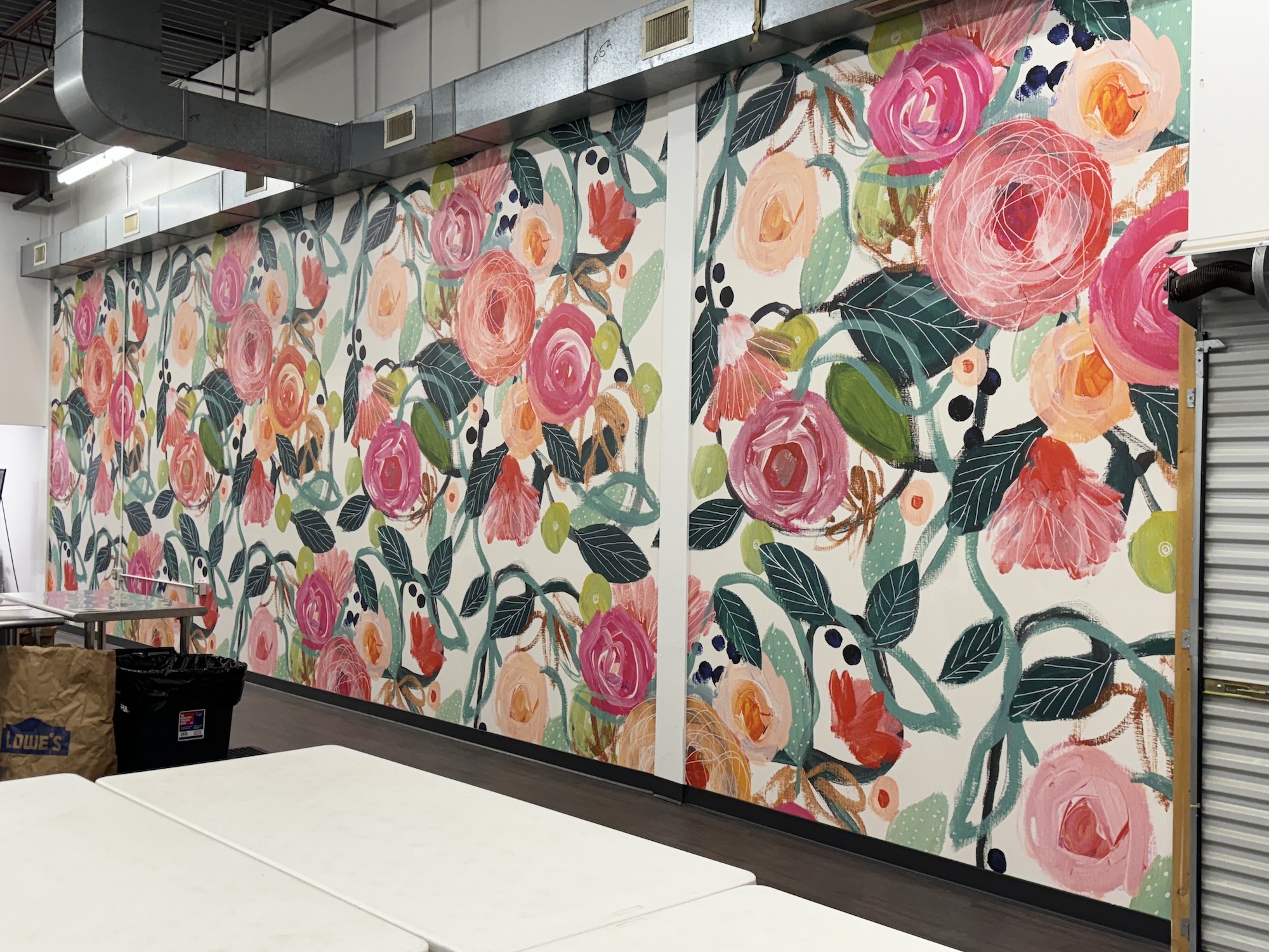 Floral mural installed on a long wall in office