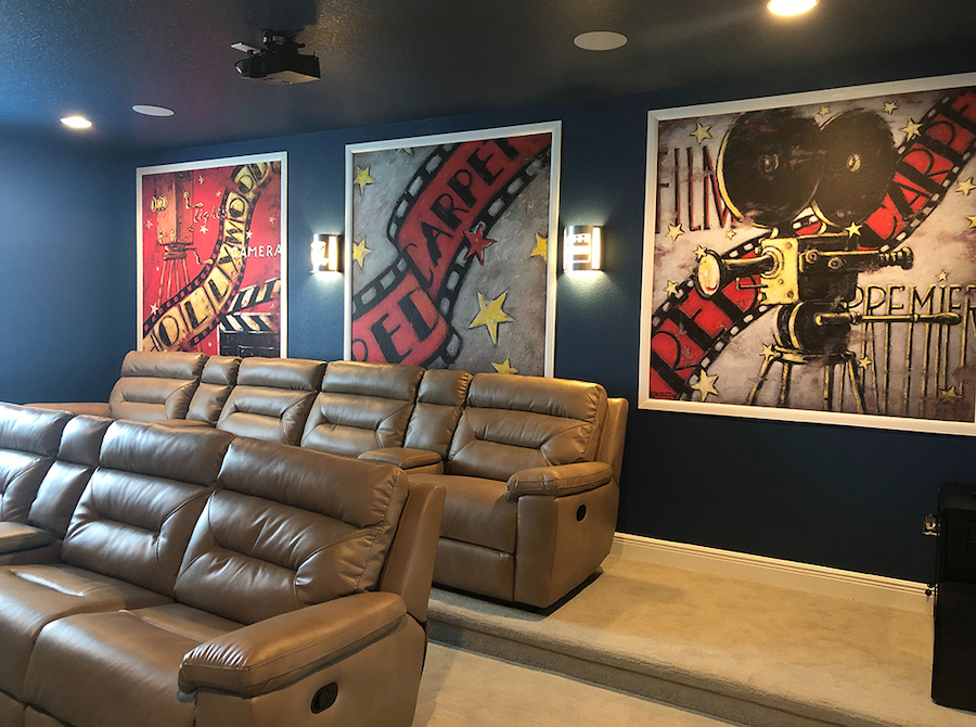 Movie theater room with three hollywood film red carpet themed wall murals