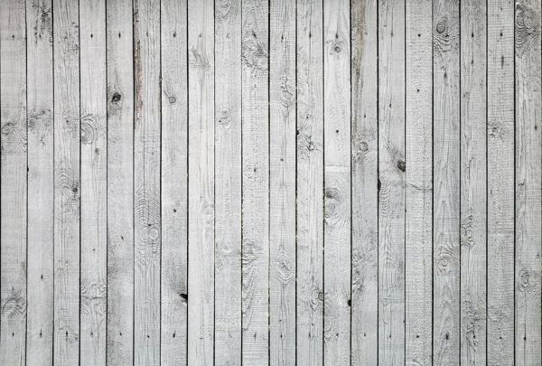 Weathered whitish grey vertical wood fence