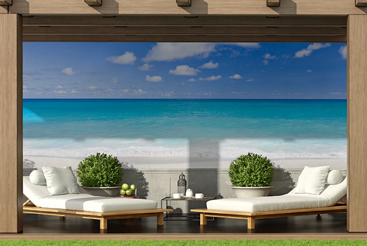 Sandy beach and tropical ocean wall mural by poolside lounges