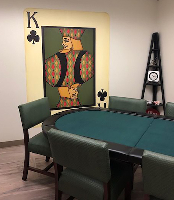 King of clubs playing card wall mural in senior living game room