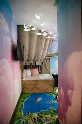 Pastel colored fluffy cloud murals on the wall of this customer's space