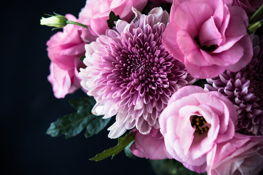 Close up photo of a mixed bouquet of pink flowers 