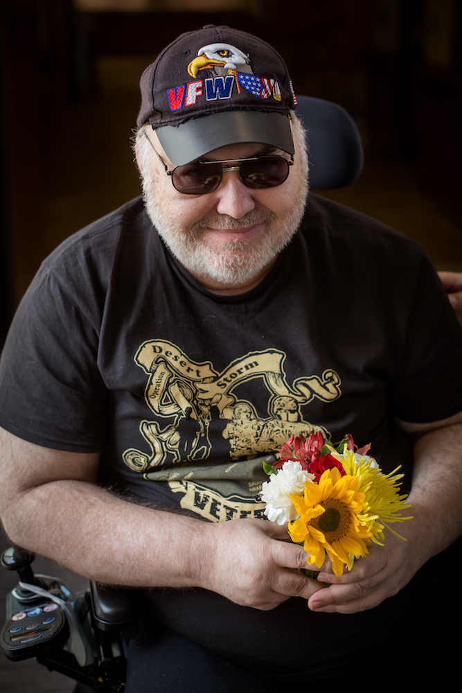 A veteran holding flowers