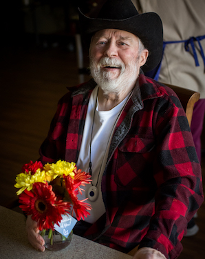 A man holding flowers from Bluebirds and Blooms