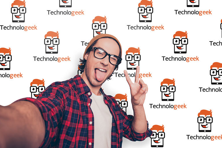 man taking selfie in front of company logo wall mural