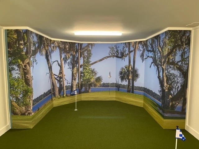 Golf green and lake mural in an indoor putting green