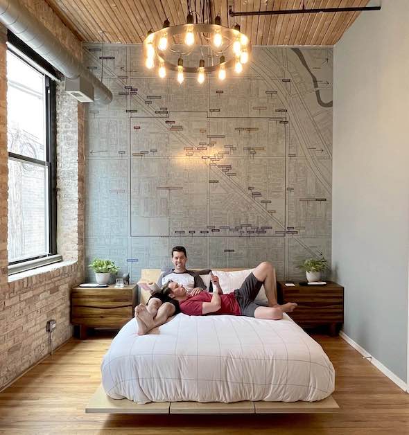 A custom map mural adorns the wall in a bedroom
