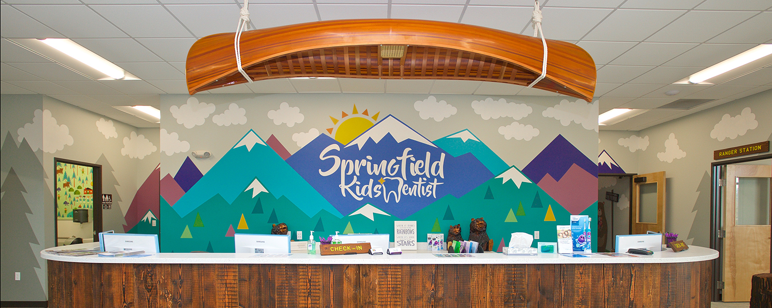 Pediatric dental office reception desk with csutom mountain kids illustration wall mural