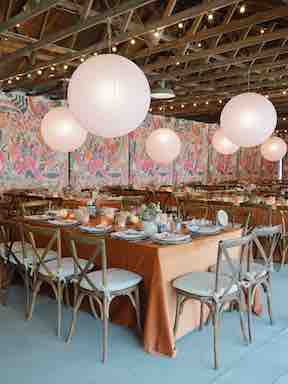 Pink Flower Wall Mural Used As Backdrop For A Rehearsal Dinner In A Barn