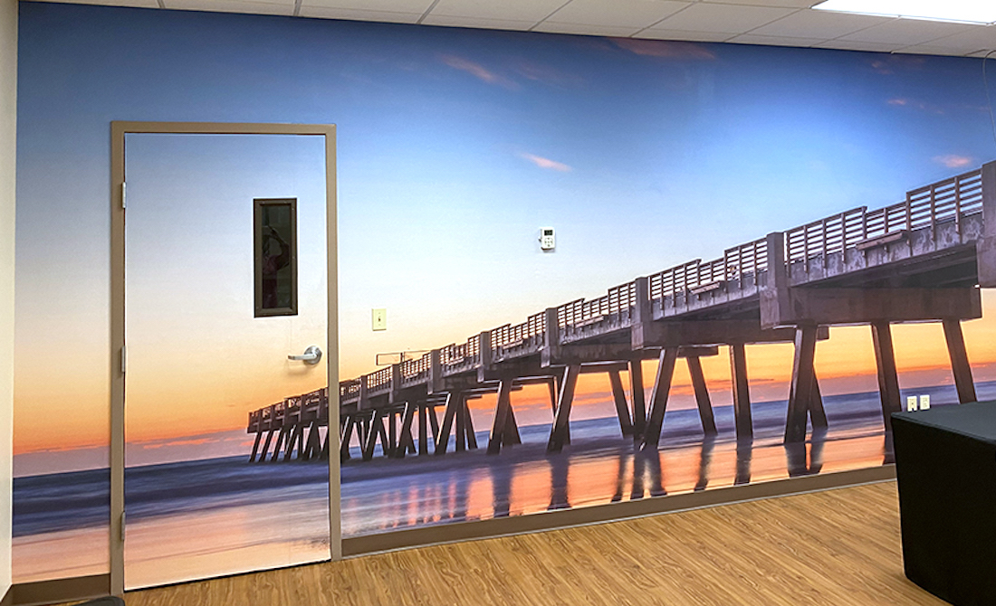 Panoramic jacksonville pier beach mural covering a wall and door