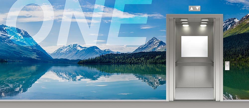 Wall Mural Of Snow Capped Mountains And Forest Covered Hills Reflected In A Water Surrounding An Elevator On 1st Floor