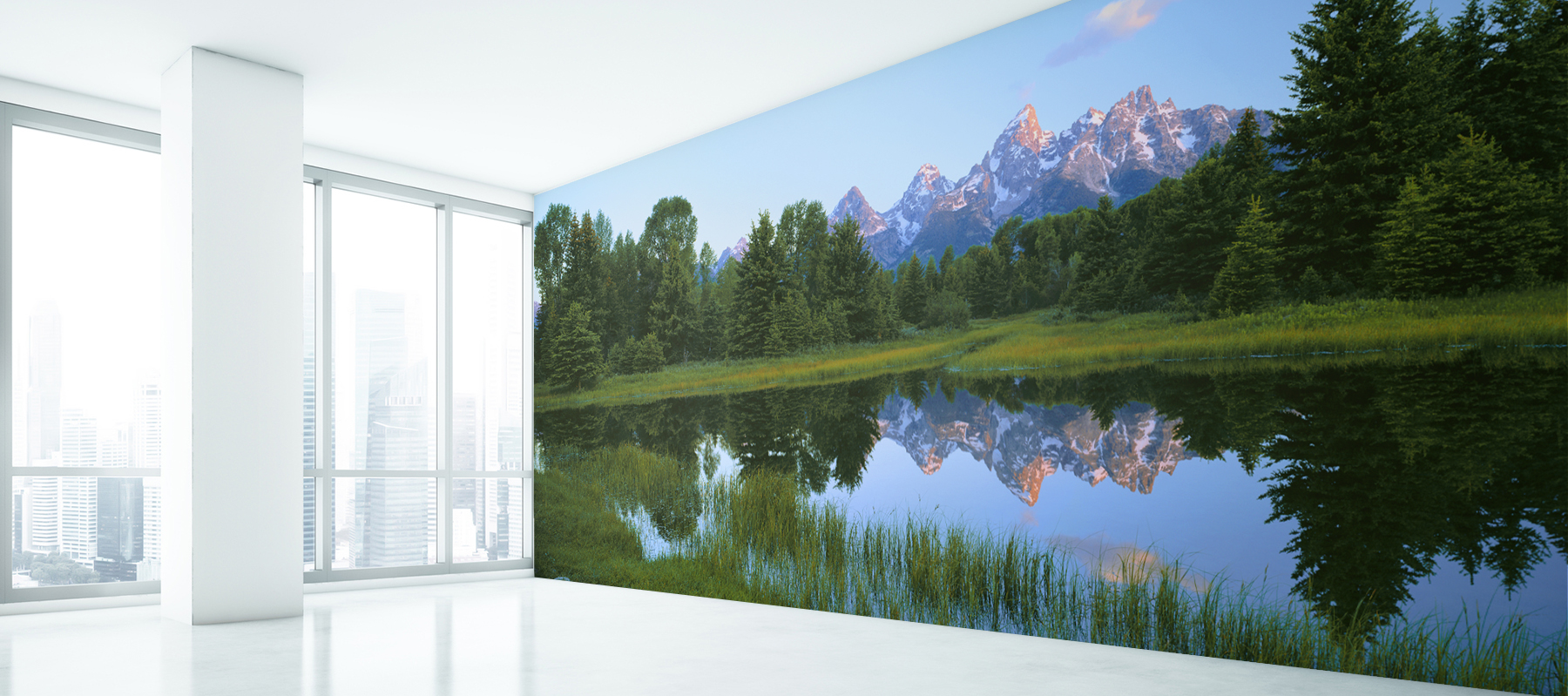 Panoramic view of snow capped Grand Tetons reflected in a lake