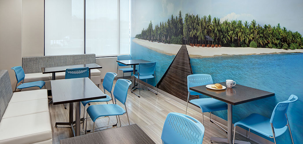 Tropical mural of a pier leading to a island beach in a breakroom