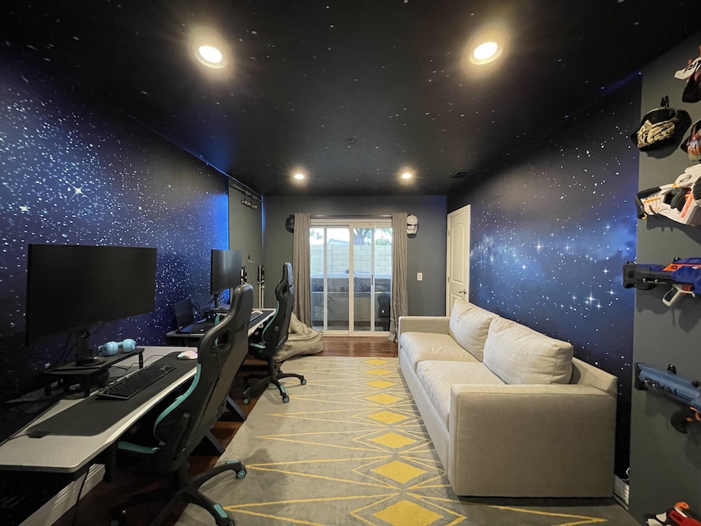 Star murals on the ceiling and walls of a video gaming room
