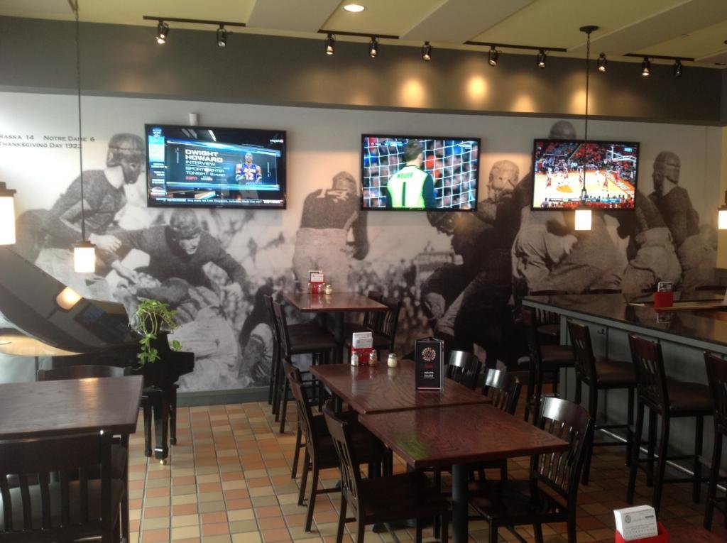 Vintage mural of football players in a bar