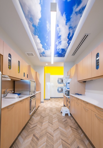 Puffy white cloud sky photo ceiling mural in medical office