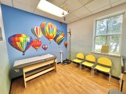 Bright multi-colored hot air balloon wall mural in a medical office