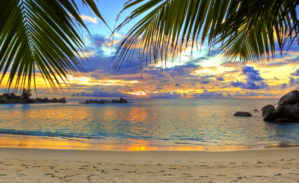 Calm ocean waters in a beach cove at sunset